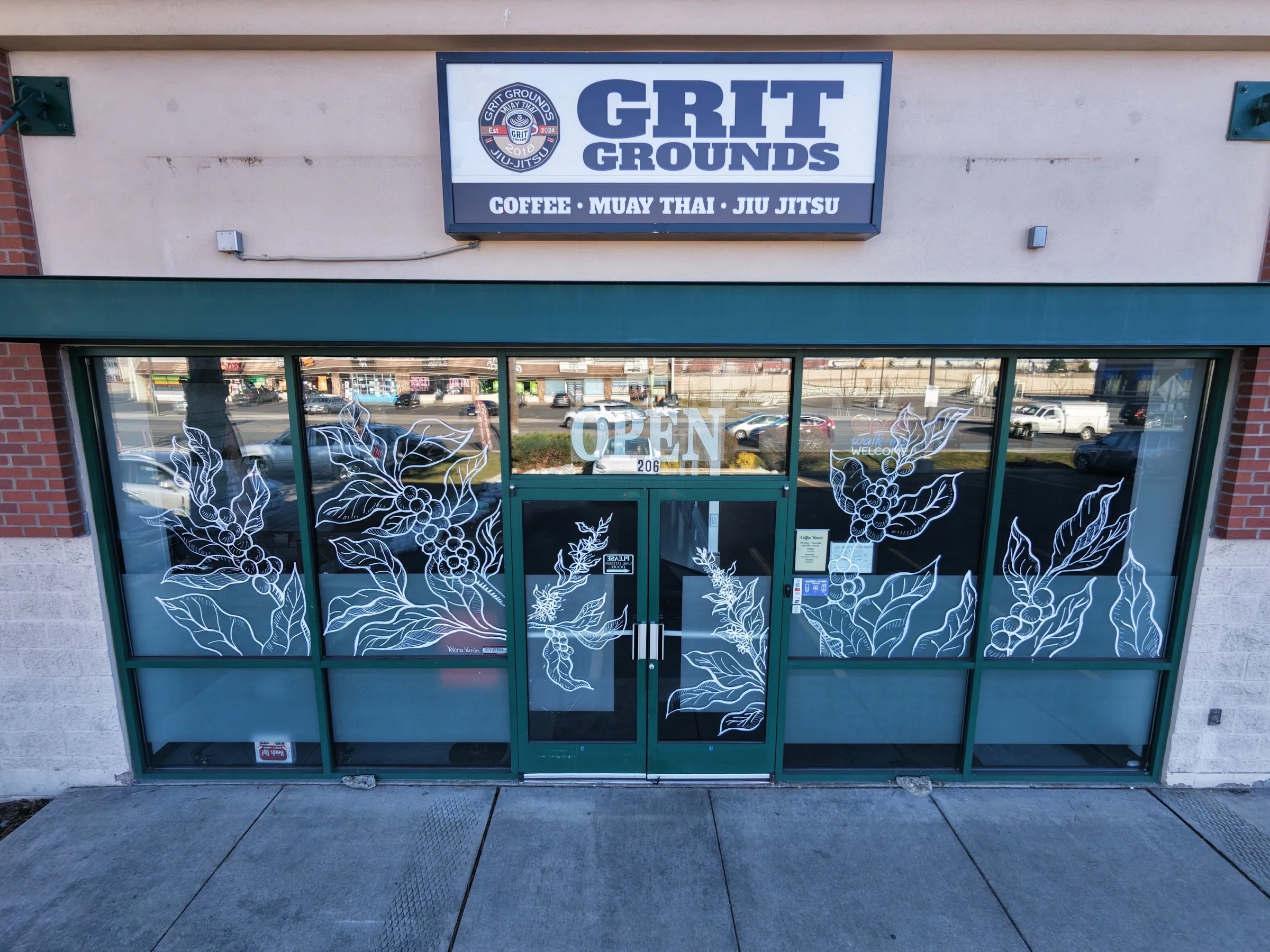 Grit Grounds storefront by day, doors marked 206 under the sign